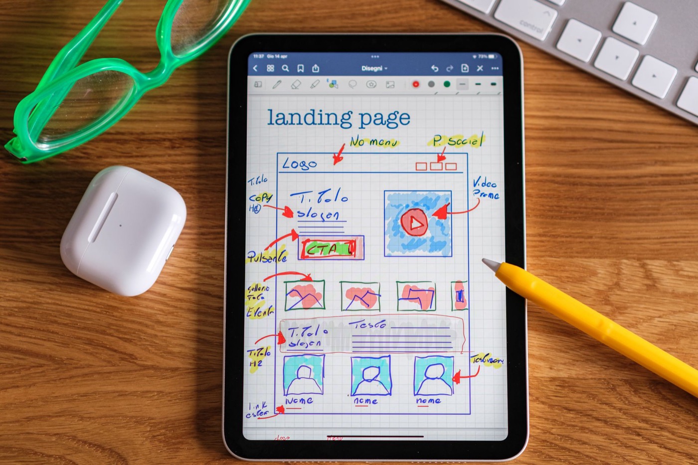 Close-up of tablet showing a hand-drawn landing page design.