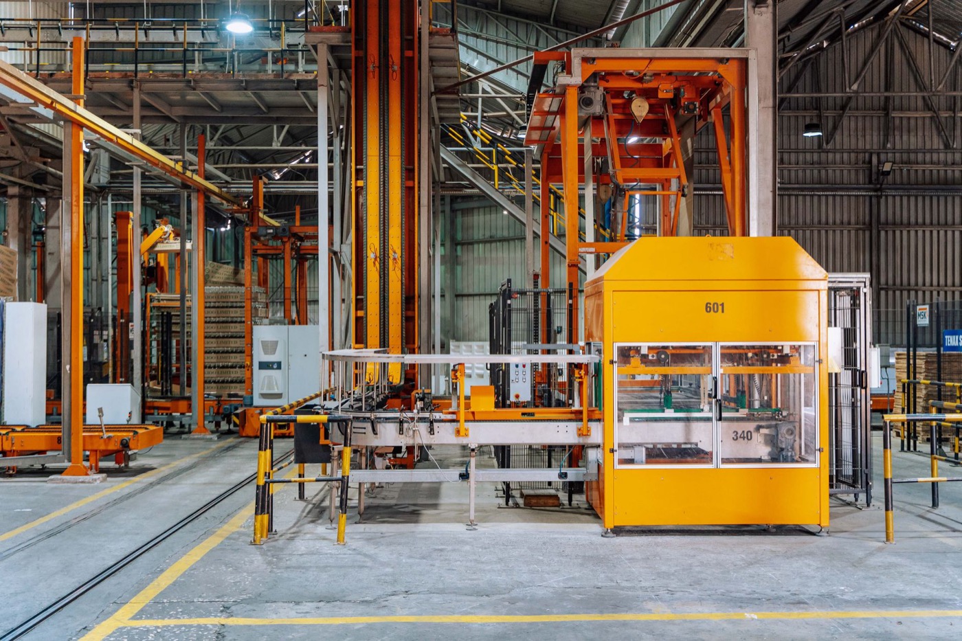 Detailed view of machinery in an operational glass factory in Dar es Salaam.